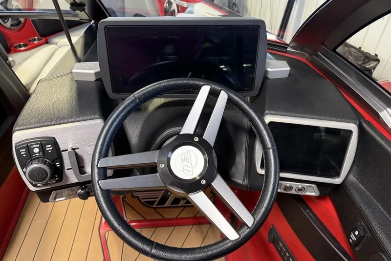 Slide: The Image of 2019 Malibu Wakesetter 23 LSV dashboard with steering wheel and digital displays. - 15