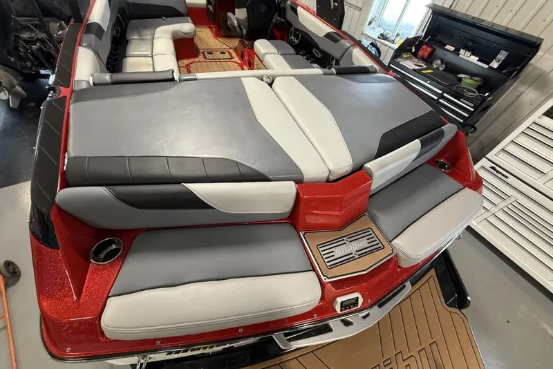 Slide: The Image of 2019 Malibu Wakesetter 23 LSV interior with red and gray seating, in a workshop setting. - 21