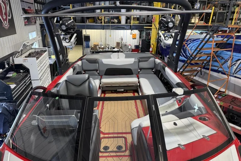 Slide: The Image of 2019 Malibu Wakesetter 23 LSV interior with sleek seating and modern design in a workshop. - 23