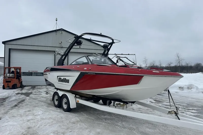Slide: The Image of 2019 Malibu Wakesetter 23 LSV boat on trailer, parked outside snowy garage. - 4