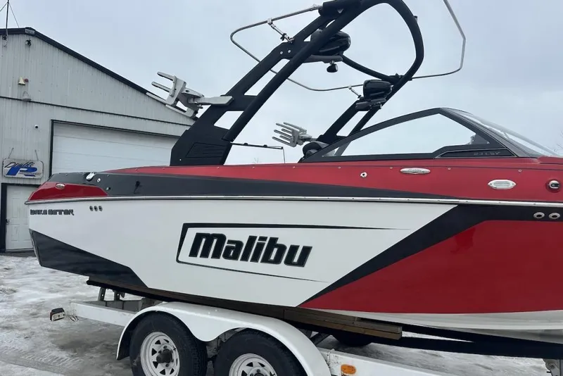 Slide: The Image of 2019 Malibu Wakesetter 23 LSV boat on trailer, red and white design. - 6