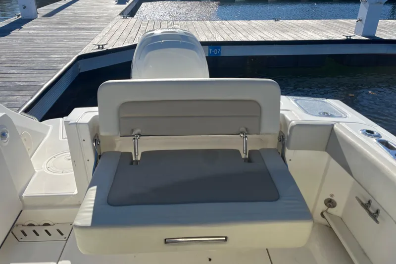 Slide: The Image of 2021 Boston Whaler 240 Vantage boat interior with foldable seating at the dock. - 11