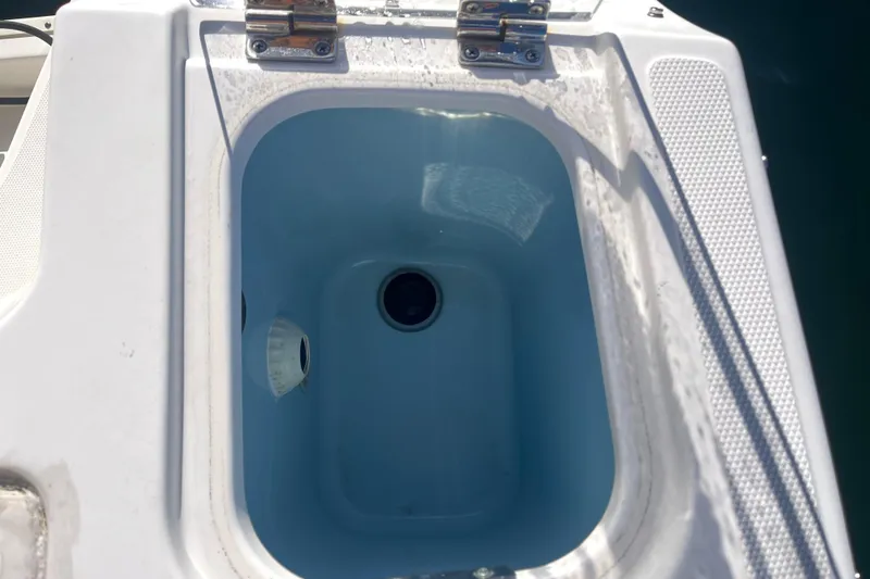 Slide: The Image of Livewell on 2021 Boston Whaler 240 Vantage boat, open lid, blue interior. - 13