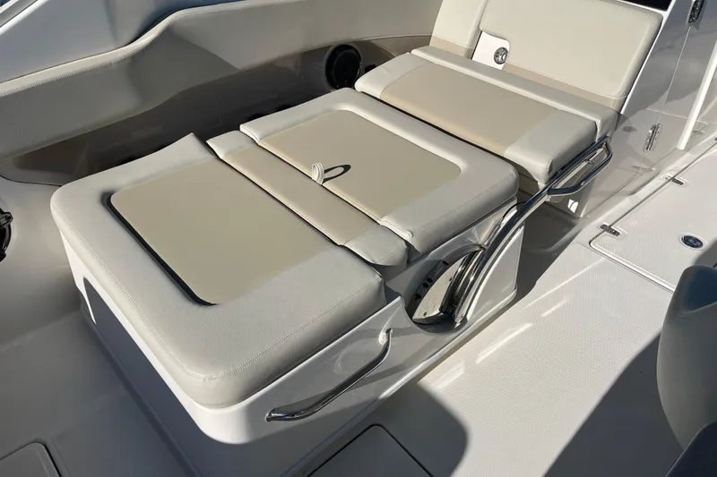Slide: The Image of 2021 Boston Whaler 240 Vantage boat seating area with cushioned seats and stainless steel handles. - 16