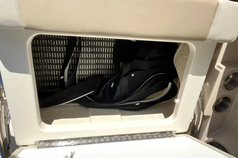 Slide: The Image of Storage compartment on a 2021 Boston Whaler 240 Vantage boat with gear inside. - 17