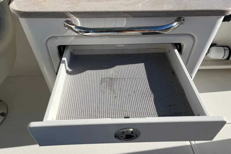 Slide: The Image of Open storage drawer on a 2021 Boston Whaler 240 Vantage boat. - 22
