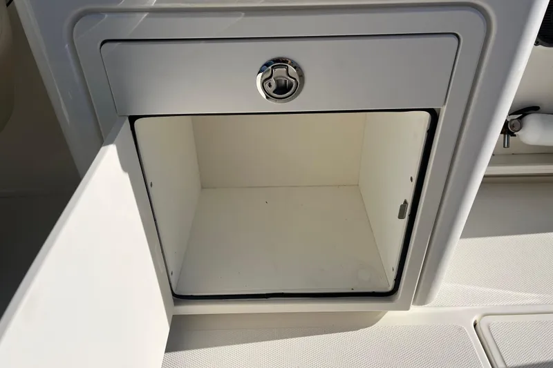 Slide: The Image of Open storage compartment on 2021 Boston Whaler 240 Vantage boat. - 23