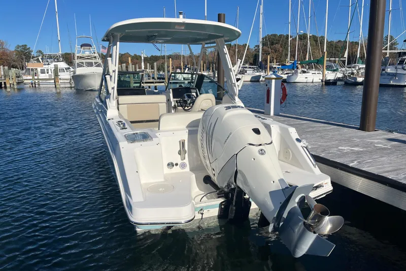 Slide: The Image of 2021 Boston Whaler 240 Vantage boat docked at marina, rear view. - 25