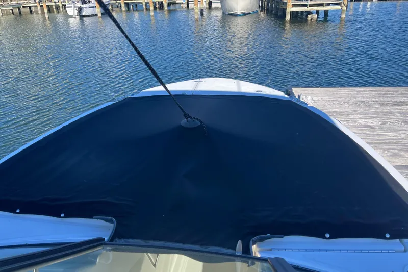 Slide: The Image of 2021 Boston Whaler 240 Vantage boat docked with cover on bow. - 27