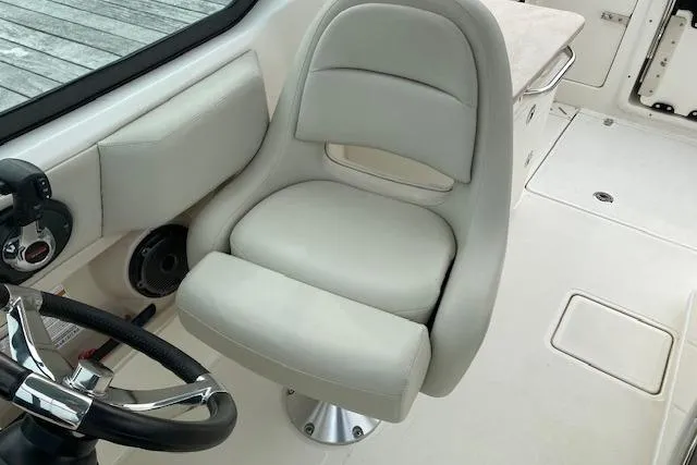Slide: The Image of 2021 Boston Whaler 240 Vantage boat interior with cushioned seating and speakers. - 3