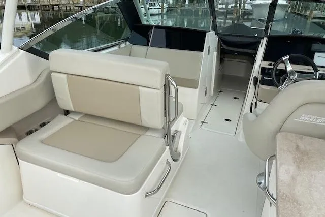 Slide: The Image of 2021 Boston Whaler 240 Vantage dashboard with steering wheel and navigation controls. - 4