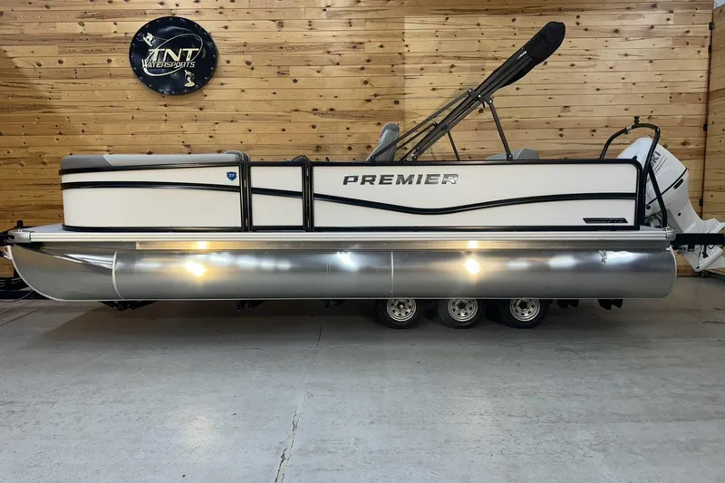The Image of 2025 Premier Sunscape 220 RL pontoon boat in showroom, wooden wall background. - 1