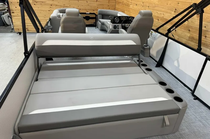 Slide: The Image of 2025 Premier Sunscape 220 RL boat interior with gray seating and cup holders. - 10