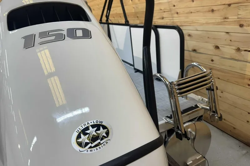 Slide: The Image of 2025 Premier Sunscape 220 RL boat engine with ultra-low emission sticker and ladder. - 3