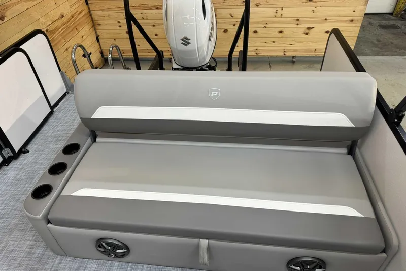 Slide: The Image of 2025 Premier Sunscape 220 RL boat interior with gray seating, cup holders, and speakers. - 8