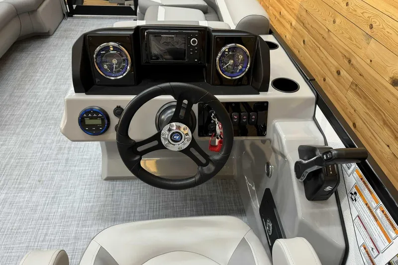 Slide: The Image of 2025 Premier Sunscape 220 RL boat dashboard with steering wheel and control panel. - 9