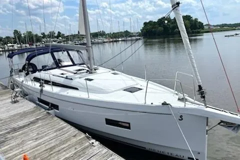 The Image of 2022 Beneteau Oceanis 40.1 sailboat docked by a serene lake. - 0