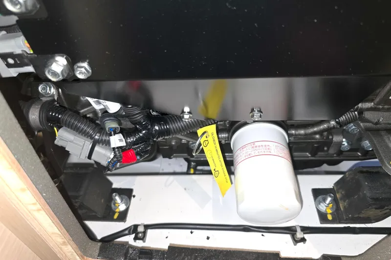 Slide: The Image of Engine compartment of a 2022 Beneteau Oceanis 40.1 sailboat, showing wiring and filter. - 14