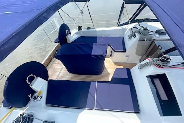 Slide: The Image of 2022 Beneteau Oceanis 40.1 yacht cockpit with blue seating and canopy. - 3