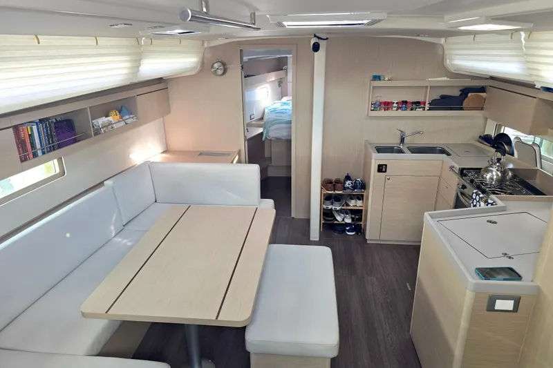 Slide: The Image of Interior of 2022 Beneteau Oceanis 40.1 yacht with modern kitchen and dining area. - 4