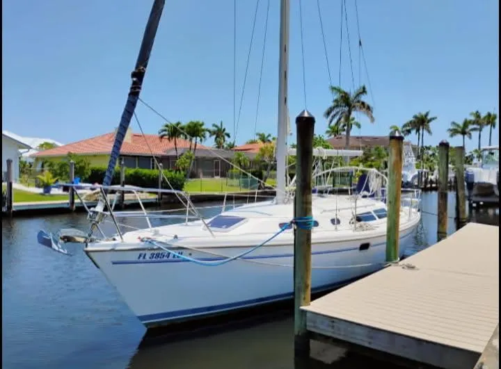 Slide: The Image of Catalina 34 Mark II sailboat docked in a sunny marina, 2002 model. - 1