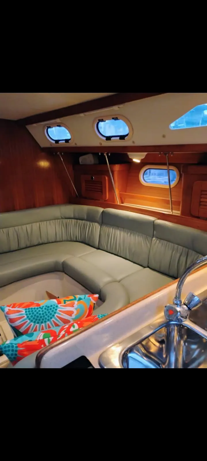 Slide: The Image of Interior of 2002 Catalina 34 Mark II sailboat with cozy seating and colorful cushions. - 5