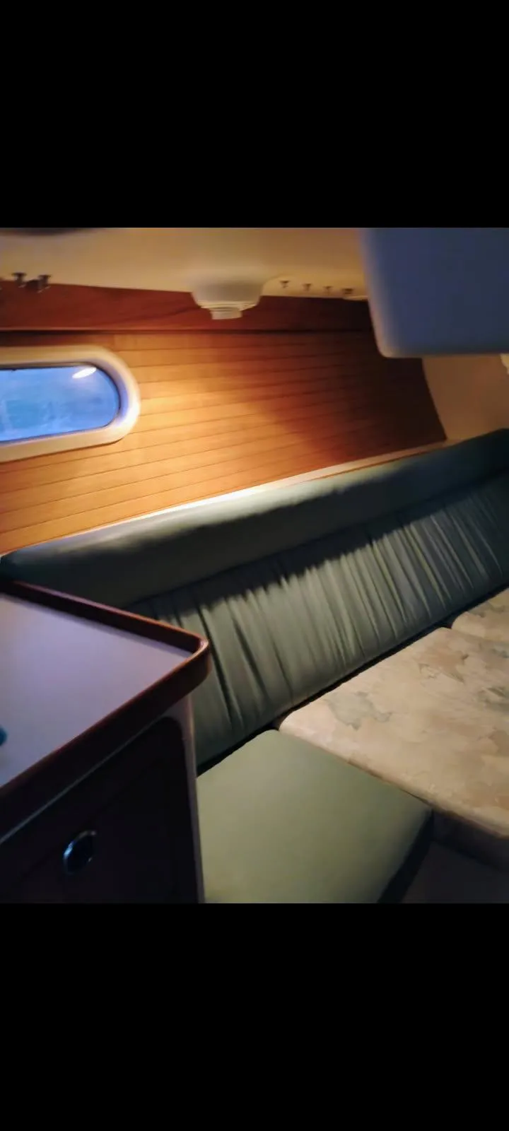 Slide: The Image of Interior of 2002 Catalina 34 Mark II sailboat with cozy seating and wooden paneling. - 8