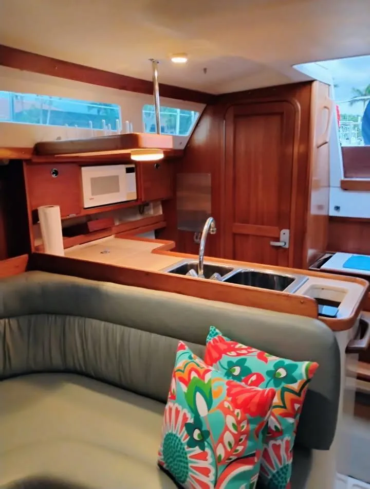 Slide: The Image of Interior of 2002 Catalina 34 Mark II sailboat with cozy seating and vibrant cushions. - 9
