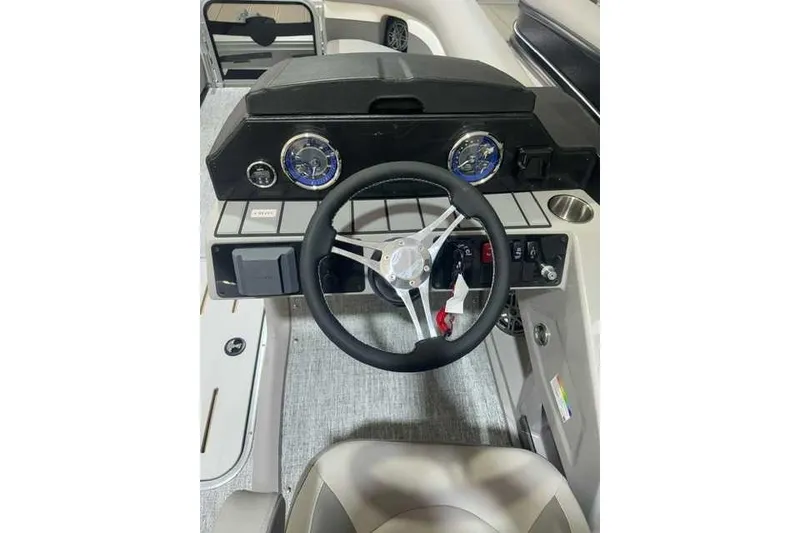 Slide: The Image of 2024 Premier 210 Sunsation RF boat dashboard with steering wheel and gauges. - 5