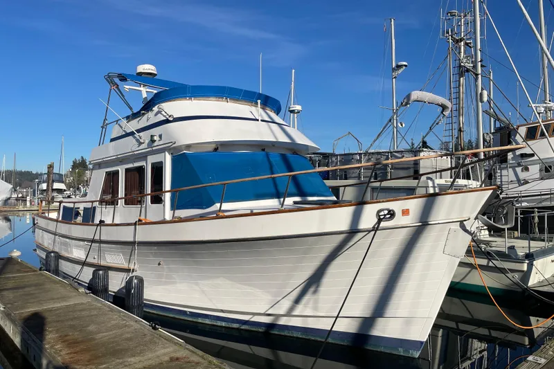 The Image of 1985 Ocean Alexander 38 Double Cabin yacht docked at marina under clear blue sky. - 0