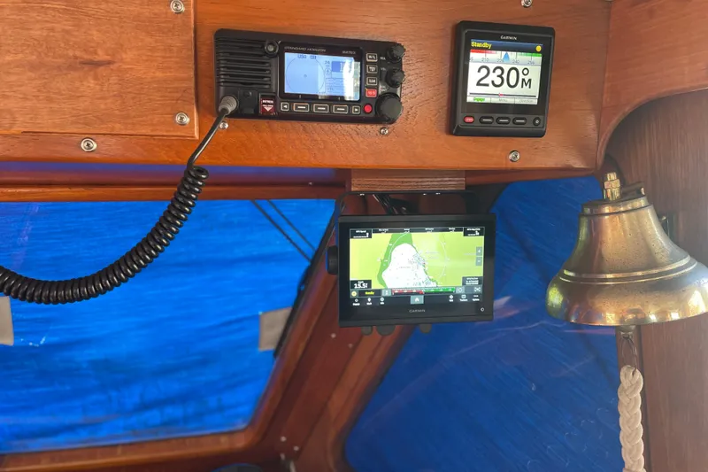 Slide: The Image of 1985 Ocean Alexander 38 Double Cabin helm with navigation equipment and brass bell. - 13