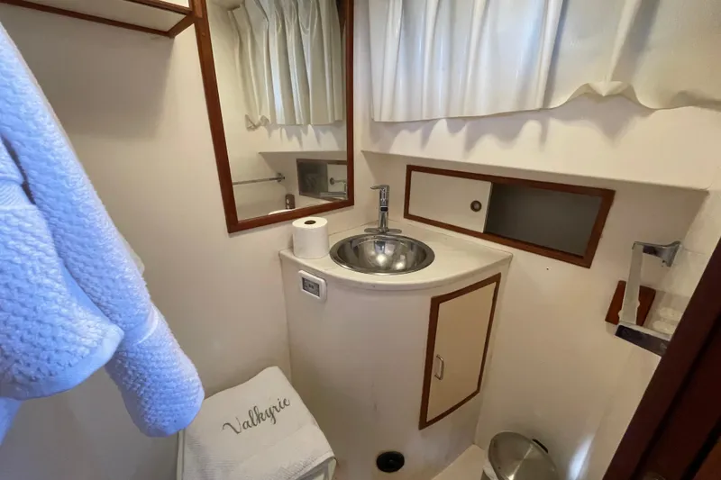 Slide: The Image of 1985 Ocean Alexander 38 Double Cabin bathroom with sink, mirror, and towel. - 20