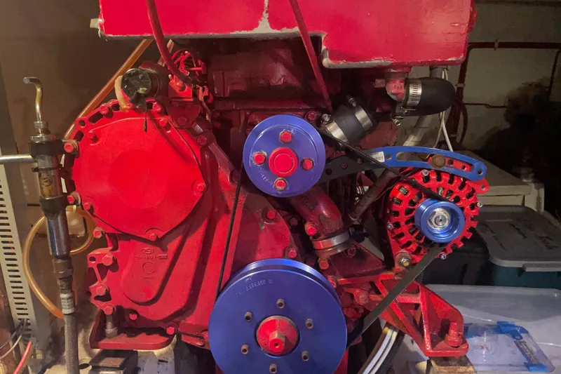 Slide: The Image of Red engine of a 1985 Ocean Alexander 38 Double Cabin boat with blue pulleys. - 31