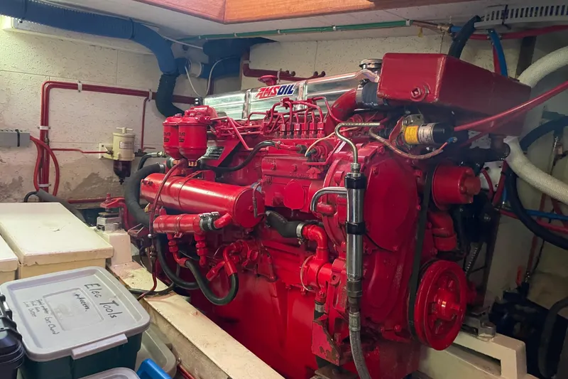 Slide: The Image of Engine room of 1985 Ocean Alexander 38 Double Cabin with red machinery and tools. - 33
