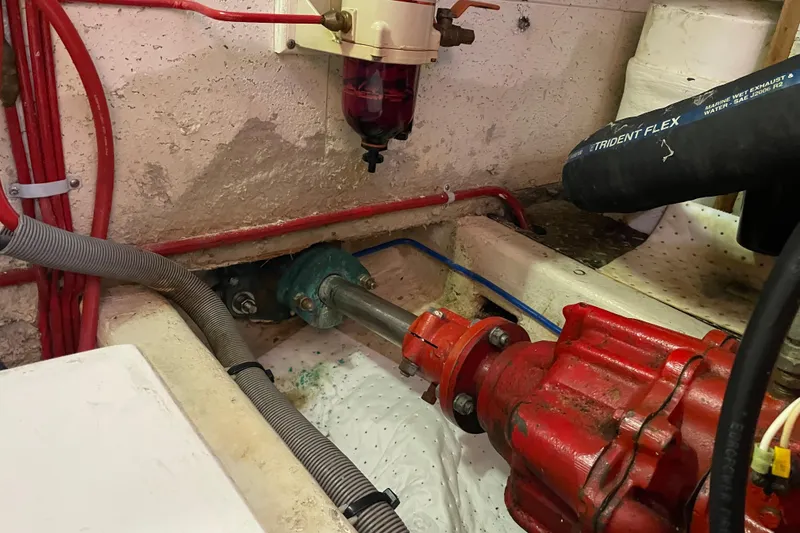 Slide: The Image of Engine compartment of 1985 Ocean Alexander 38 Double Cabin with visible hoses and components. - 35