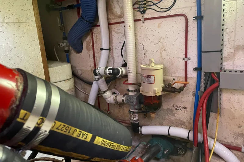 Slide: The Image of Engine room of 1985 Ocean Alexander 38 Double Cabin with pipes and fuel filter system. - 37