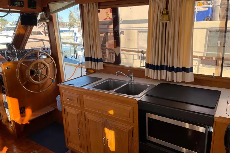 Slide: The Image of Interior of 1985 Ocean Alexander 38 Double Cabin with helm, sink, and microwave. - 8