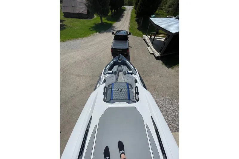Slide: The Image of 2019 Sunsation 32 CCX boat on trailer, viewed from above, with truck towing. - 5