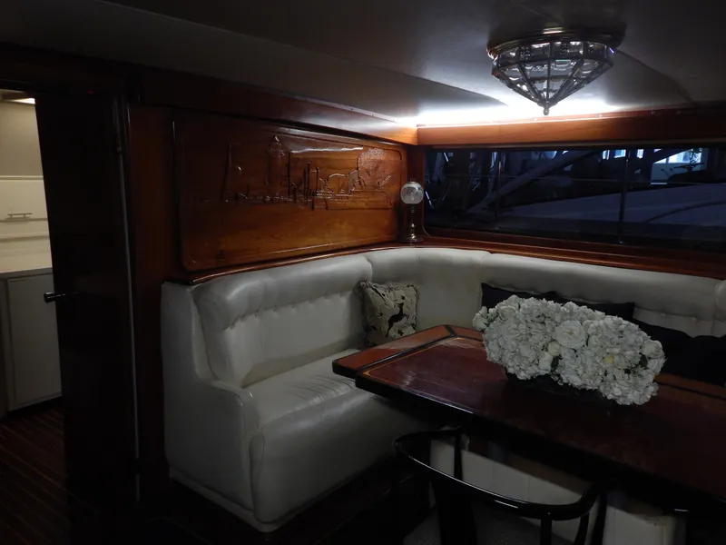 Slide: The Image of Luxurious 1974 Pacemaker Cockpit Motoryacht interior with elegant seating and floral centerpiece. - 12