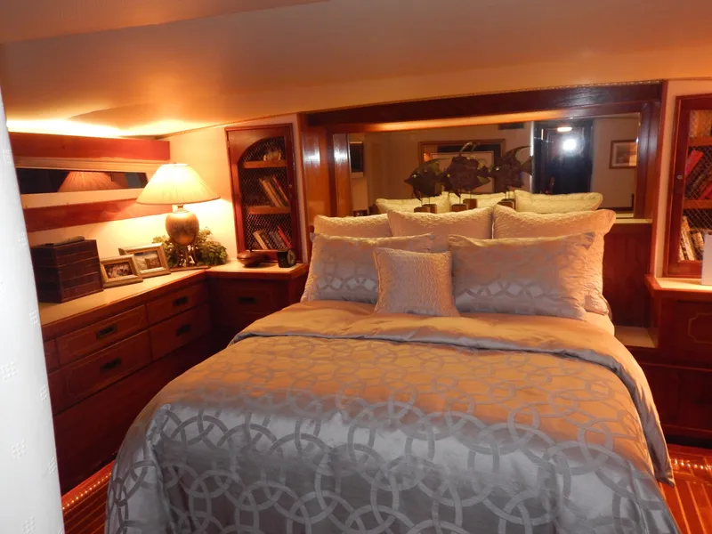 Slide: The Image of Luxurious bedroom interior of a 1974 Pacemaker Cockpit Motoryacht with elegant bedding and warm lighting. - 15