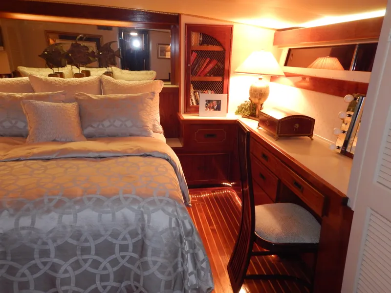 Slide: The Image of Luxurious 1974 Pacemaker Cockpit Motoryacht bedroom with elegant decor and wooden furnishings. - 16