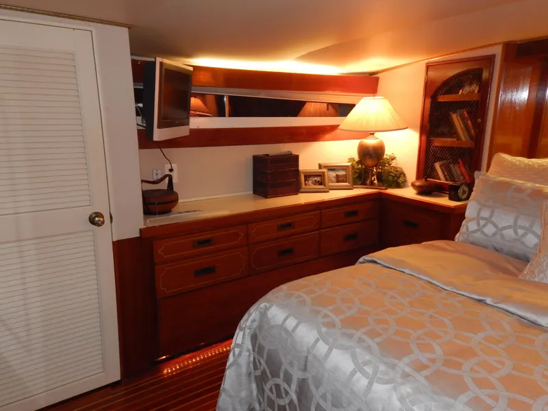 Slide: The Image of Luxurious 1974 Pacemaker Cockpit Motoryacht bedroom with elegant wood cabinetry and cozy lighting. - 19