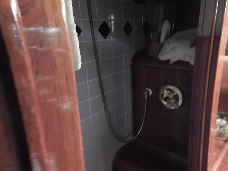 Slide: The Image of 1974 Pacemaker Cockpit Motoryacht bathroom with wooden accents and tiled walls. - 26