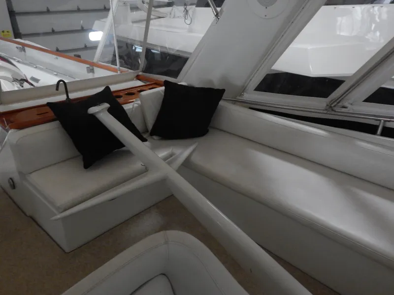 Slide: The Image of 1974 Pacemaker Cockpit Motoryacht interior with white seating and black cushions. - 27