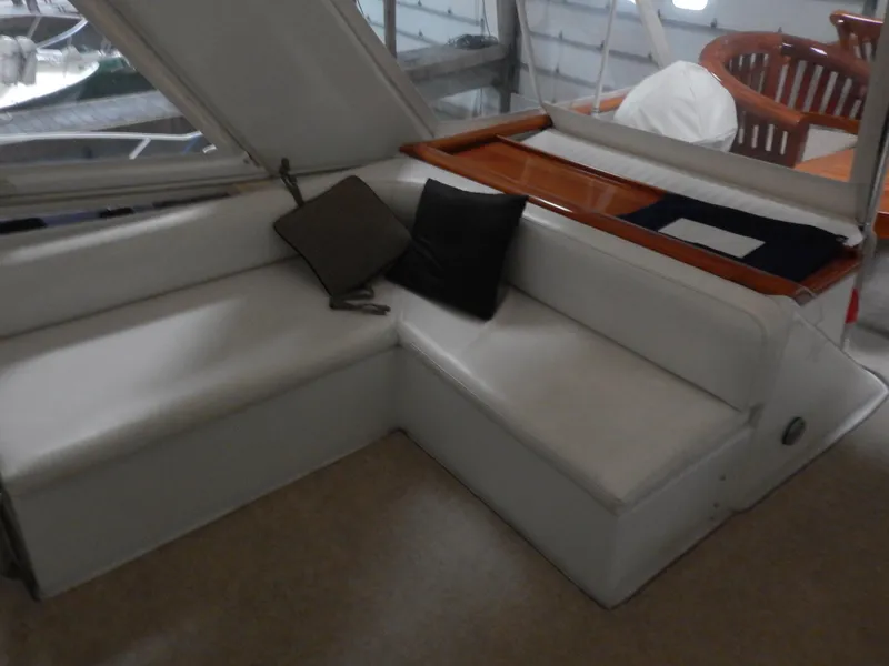 Slide: The Image of 1974 Pacemaker Cockpit Motoryacht interior with white seating and cushions. - 28