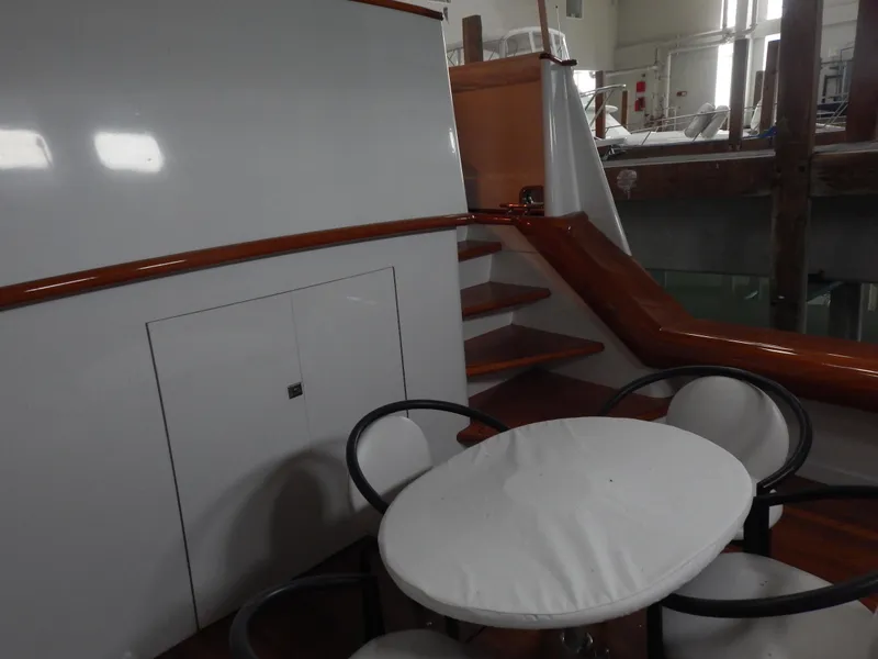 Slide: The Image of 1974 Pacemaker Cockpit Motoryacht interior with stairs and round table seating. - 36