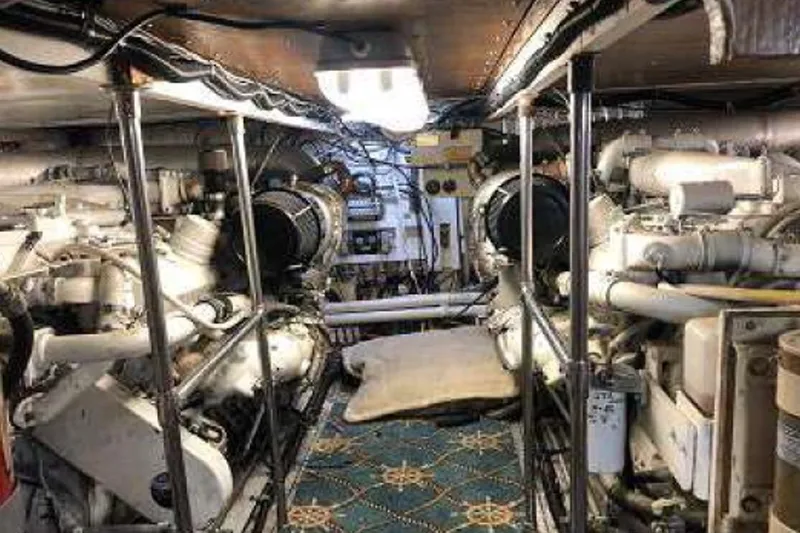 Slide: The Image of Engine room of a 1974 Pacemaker Cockpit Motoryacht, showcasing dual engines and mechanical components. - 46