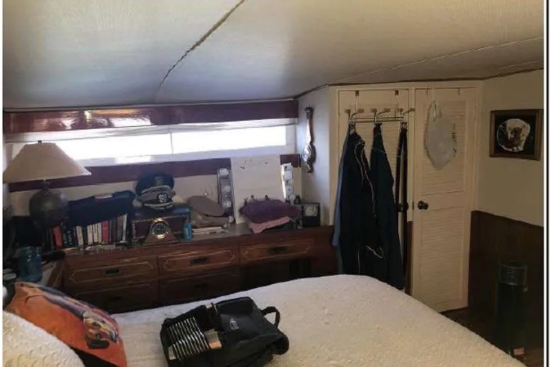 Slide: The Image of Interior of 1974 Pacemaker Cockpit Motoryacht with cozy bedroom and wooden furnishings. - 48