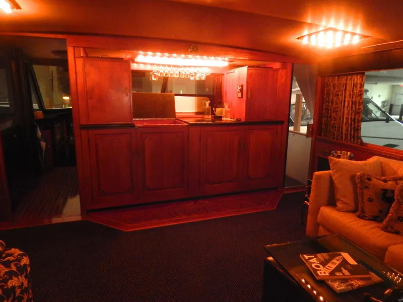 Slide: The Image of 1974 Pacemaker Cockpit Motoryacht interior with elegant wooden bar and cozy seating area. - 5