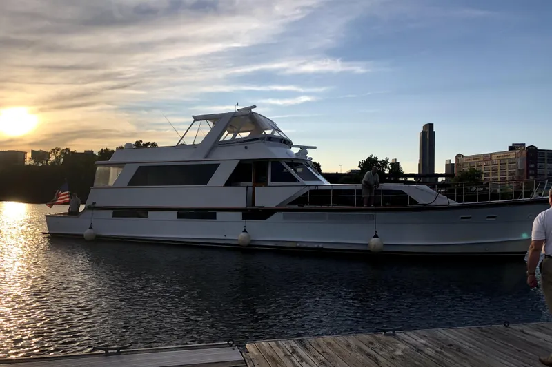 Slide: The Image of 1974 Pacemaker Cockpit Motoryacht docked at sunset, with city skyline in background. - 53